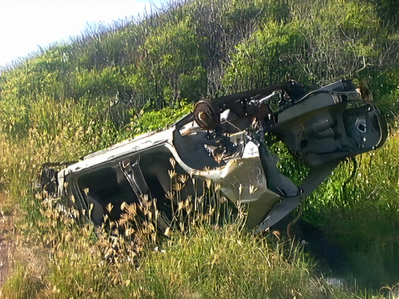 QuadraCam — wrecked car overgrown roadside